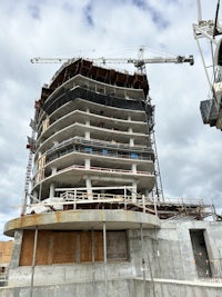 a building under construction with a crane in the background