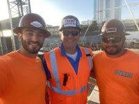 three construction workers posing for a selfie