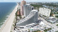 an aerial view of a building on the beach