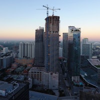 an aerial view of a city with tall buildings under construction