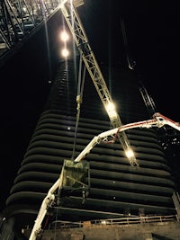 a crane lifting a large building at night