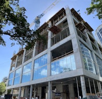 a building under construction with a crane in the background