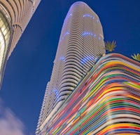 a tall building with colorful stripes in front of it