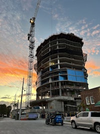 a crane is on top of a building that is under construction