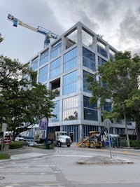 a large building with a crane in front of it