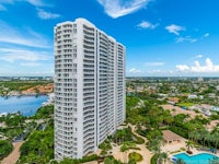 an aerial view of an apartment building near the water