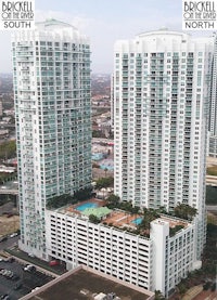 an aerial view of a large building with a swimming pool