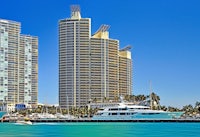 a boat is in the water next to tall buildings