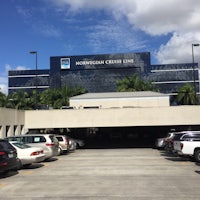 a large building with a lot of cars parked in front of it