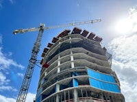 a building under construction with a crane in the background