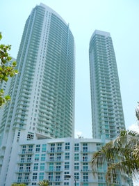 a white building with a palm tree in front of it