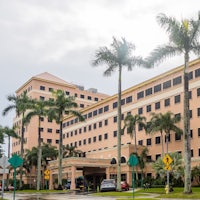 a large building with palm trees in front of it