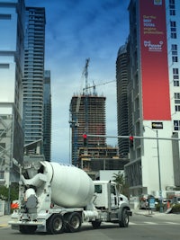 a cement mixer truck driving down the street